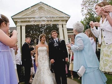 A bride and groom walking down the aisle.
