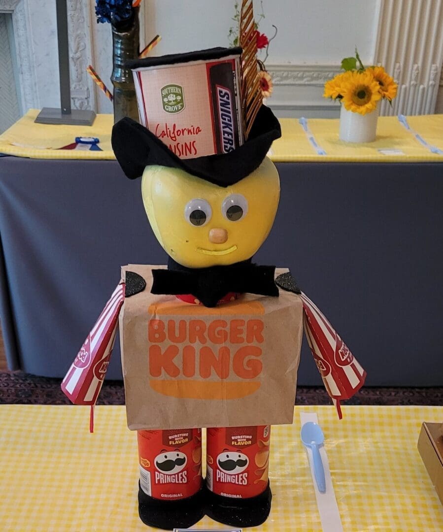 wcd junk A toy character is wearing a top hat and holding a bag.