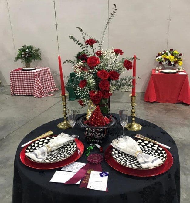 A table with two plates and candles on it