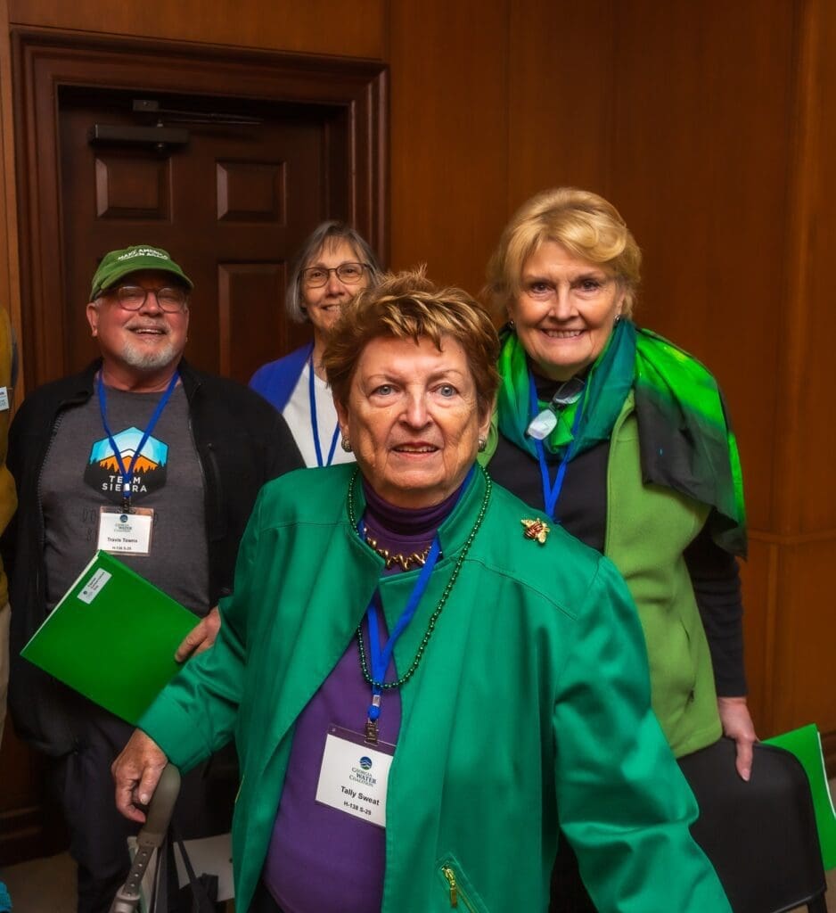 A group of people standing in front of a door.