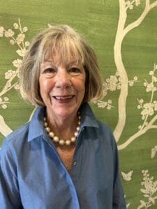 A woman with short hair and a blue shirt.
