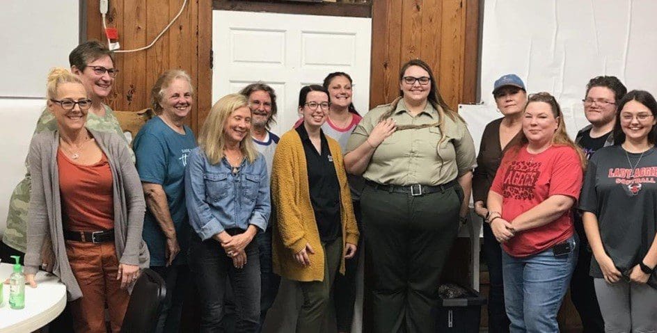 A group of people standing in front of a door.