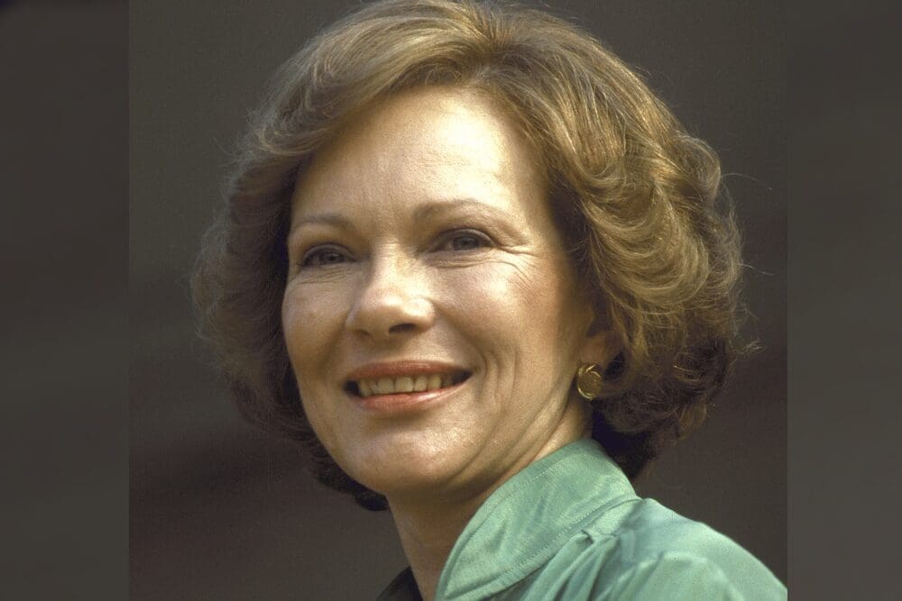 A woman with short hair smiles for the camera.