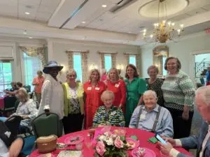 A group of people standing around a table.