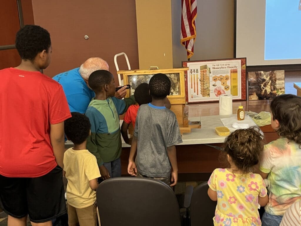 A group of people standing around looking at an exhibit.