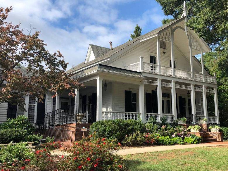 marietta garden center A large white house with a porch and balcony.