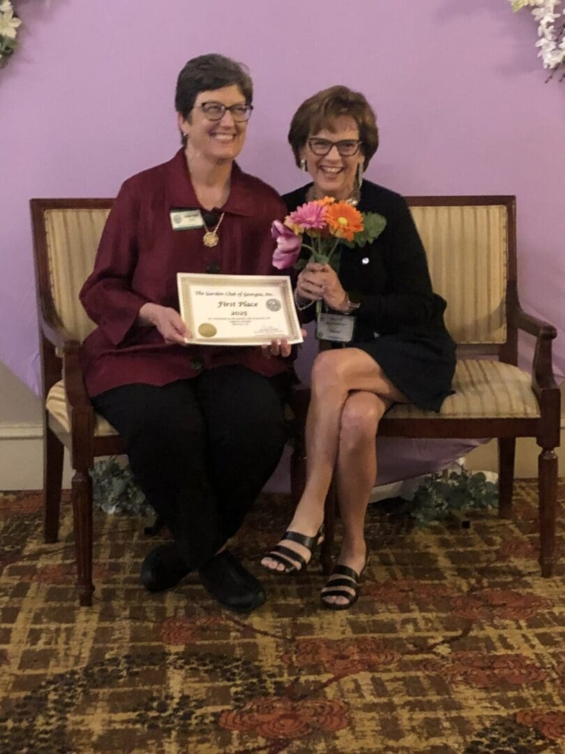 Roswell Garden Club president Debbie Vann receives one of their many first-place awards from President Lisa Hall, Augusta 2025