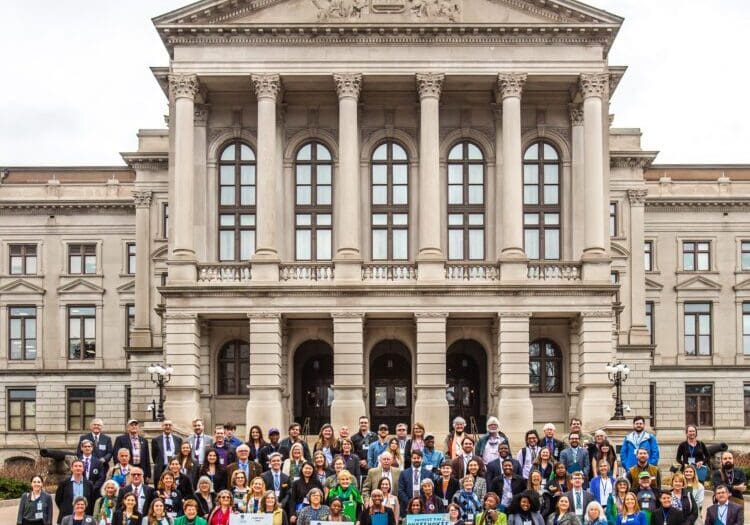 Group photo on steps of Capitol 2023 with dome Group photo on Steps of Capitol 2023
